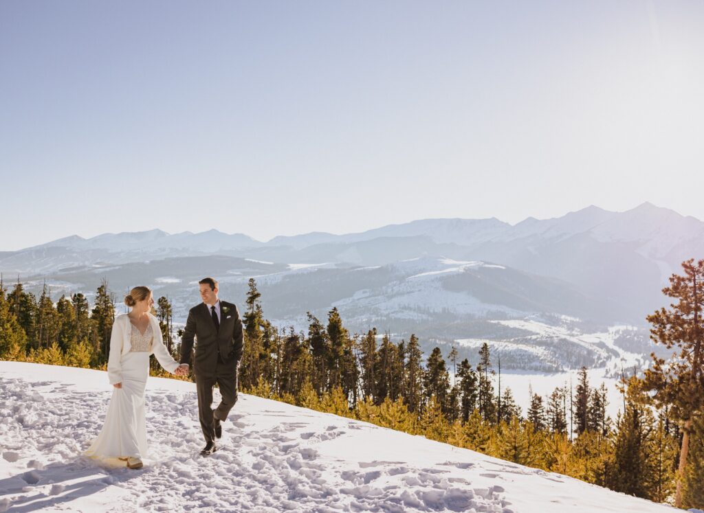 Couple walking in the snow at Sapphire Point Overlook for elopement