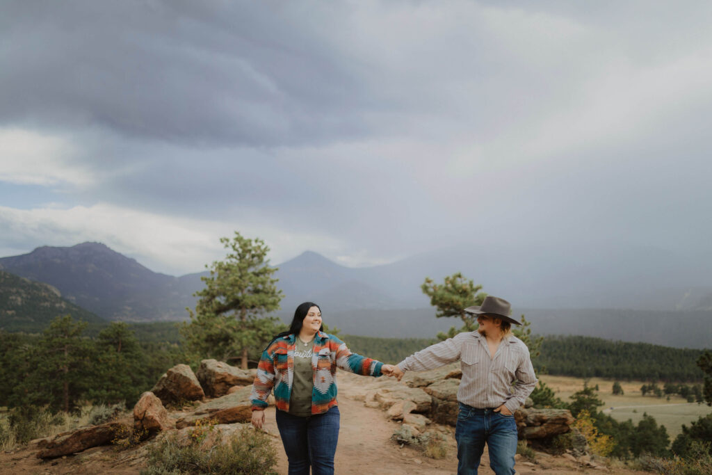 Couple holding hands at Rocky Mountain National Park