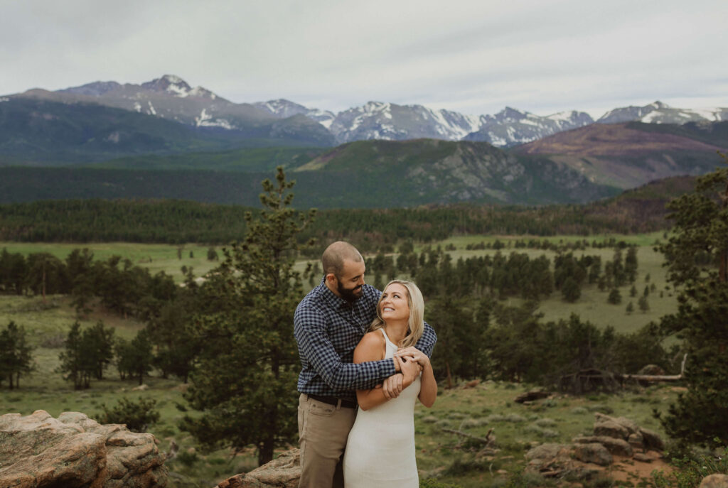 Couple backed by mountains at Rocky Mountain National Park