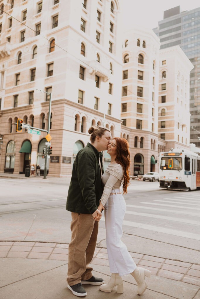 Couple kissing for proposal photos in Downtown Denver