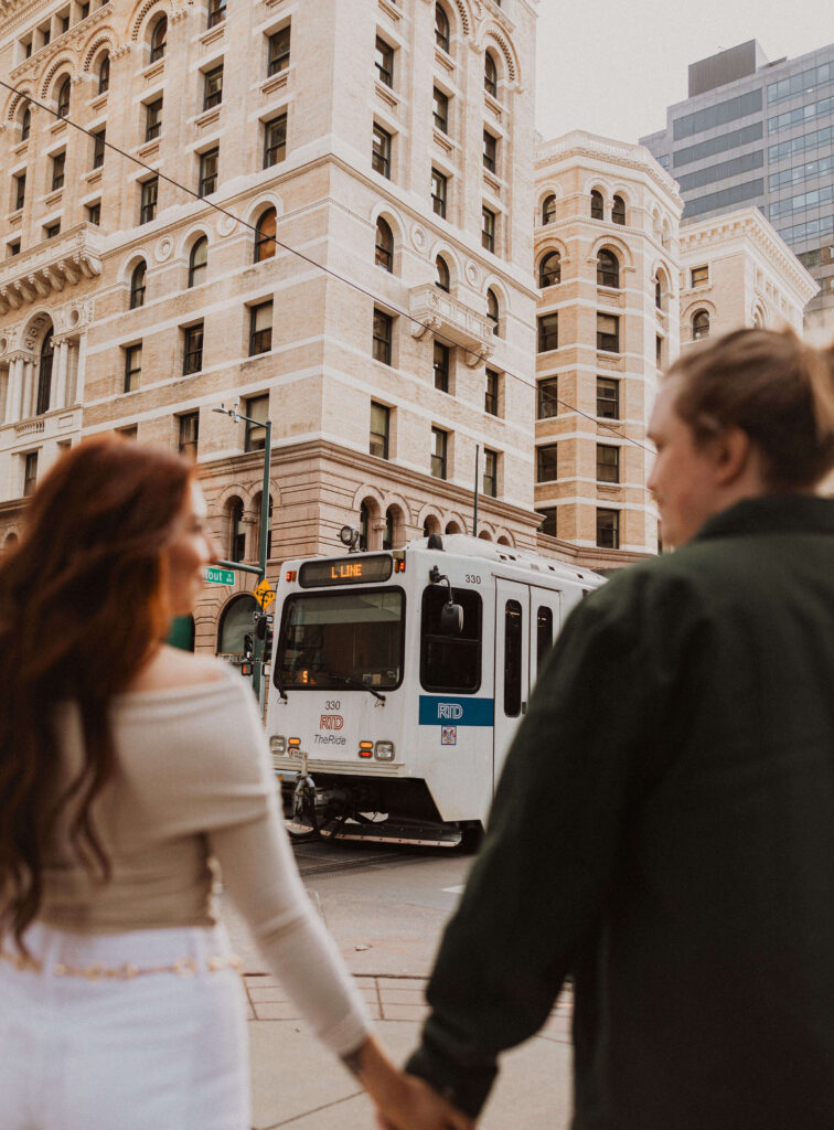 Couple taking proposal photos in Downtown Denver