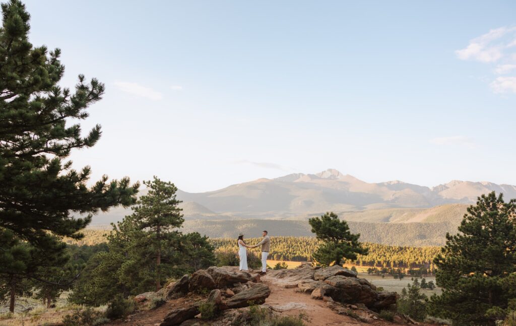 Couple posing for proposal photos at Rocky Mountain National Park