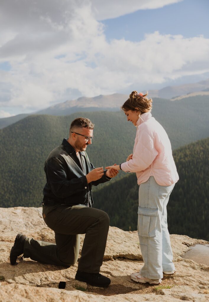 Man proposing backed by mountains in Colorado