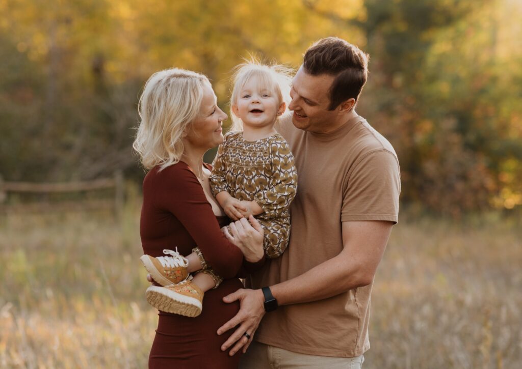 Mom, dad, and daughter posing for family photos