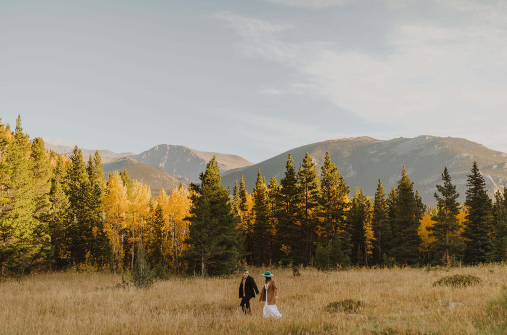 Bride and groom holding hands at Rocky Mountain National Park
