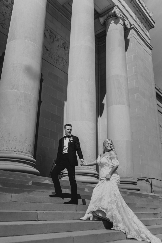 Bride and groom walking on steps at courthouse in Colorado