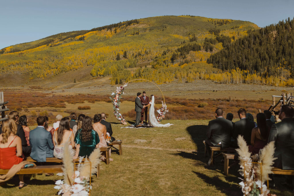 Outdoor wedding ceremony at Cement Creek ranch wedding venue in Crested Butte