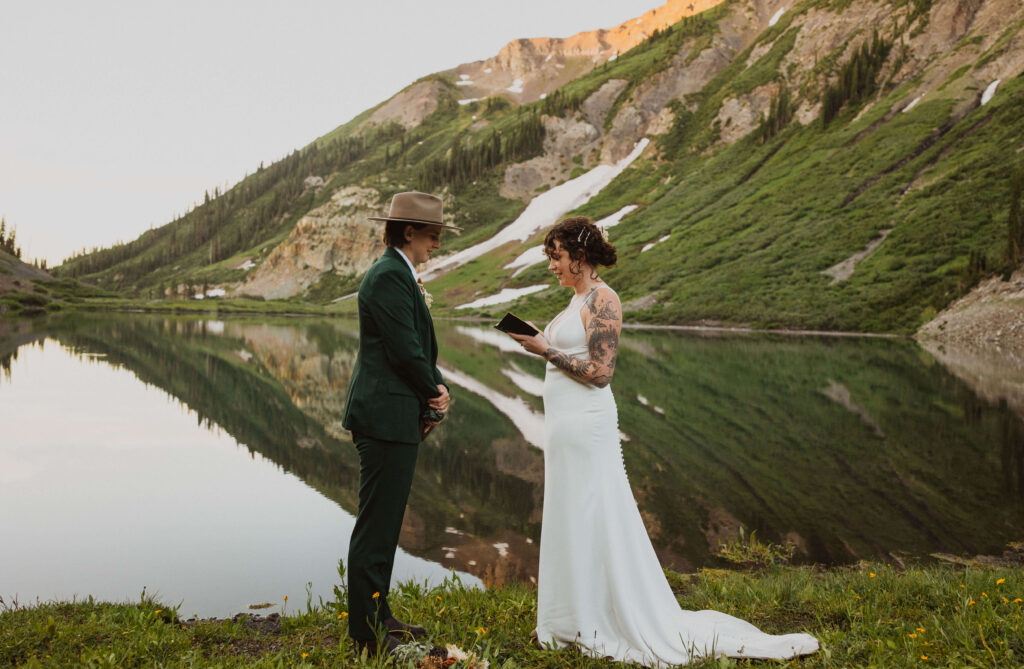 Bride reading vows in front of lake