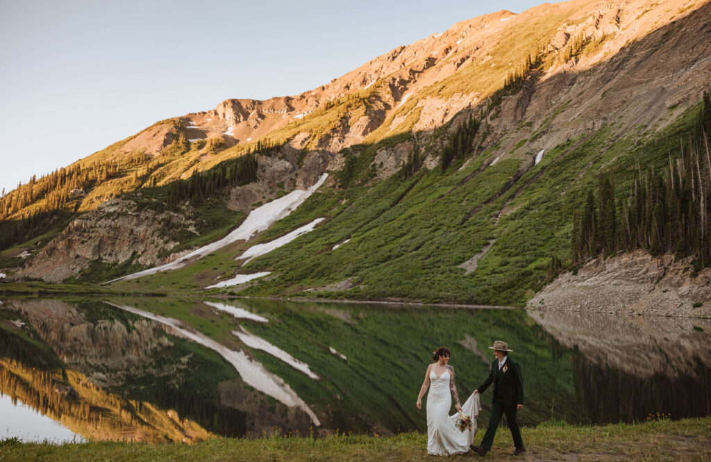Brides walking by lake for wedding in Crested Butte