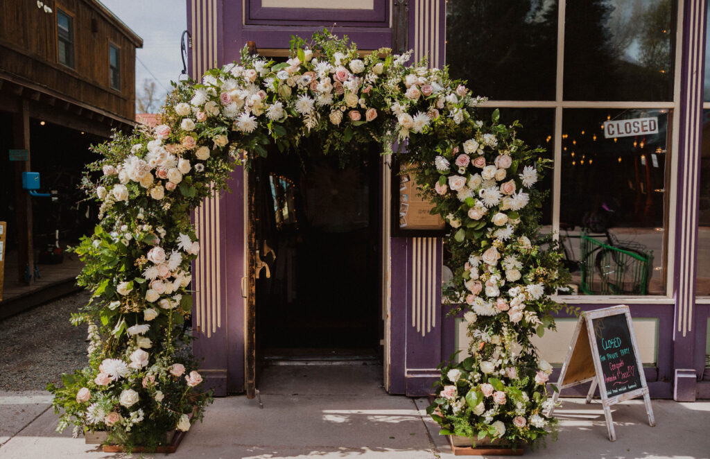 The Breadery in Crested Butte with flower arch in front for wedding receoption