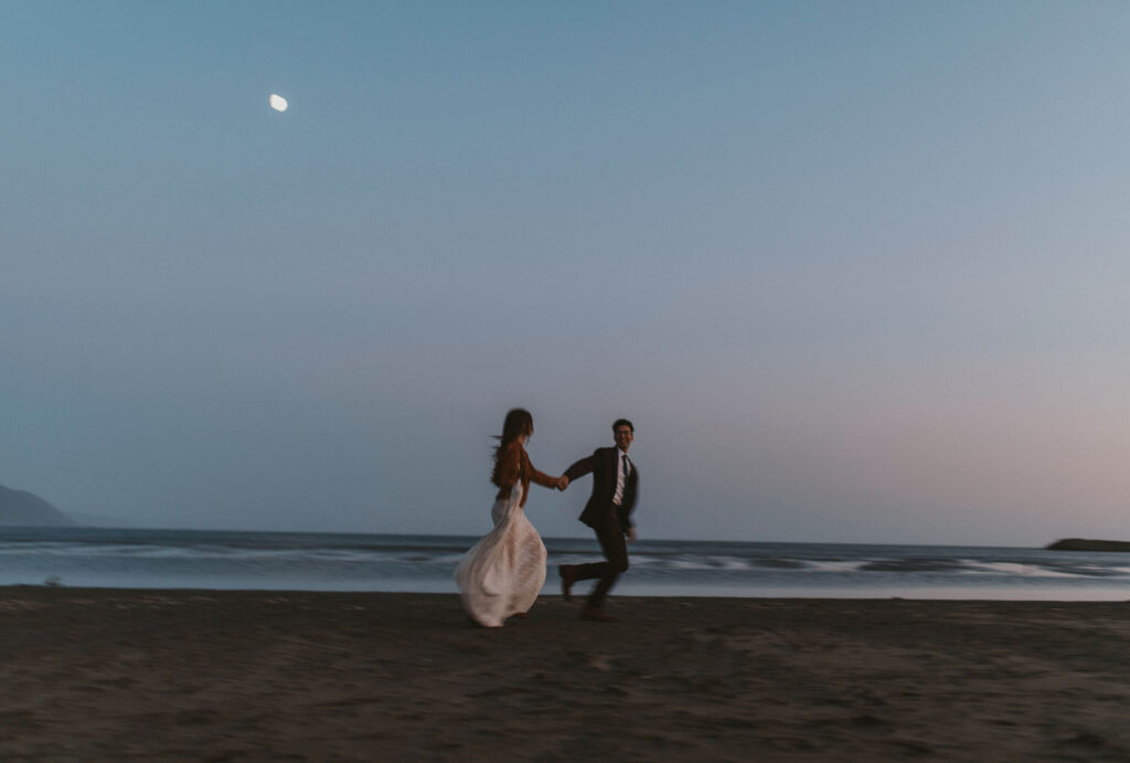 Bride and groom running on the beach for elopement in Washington State