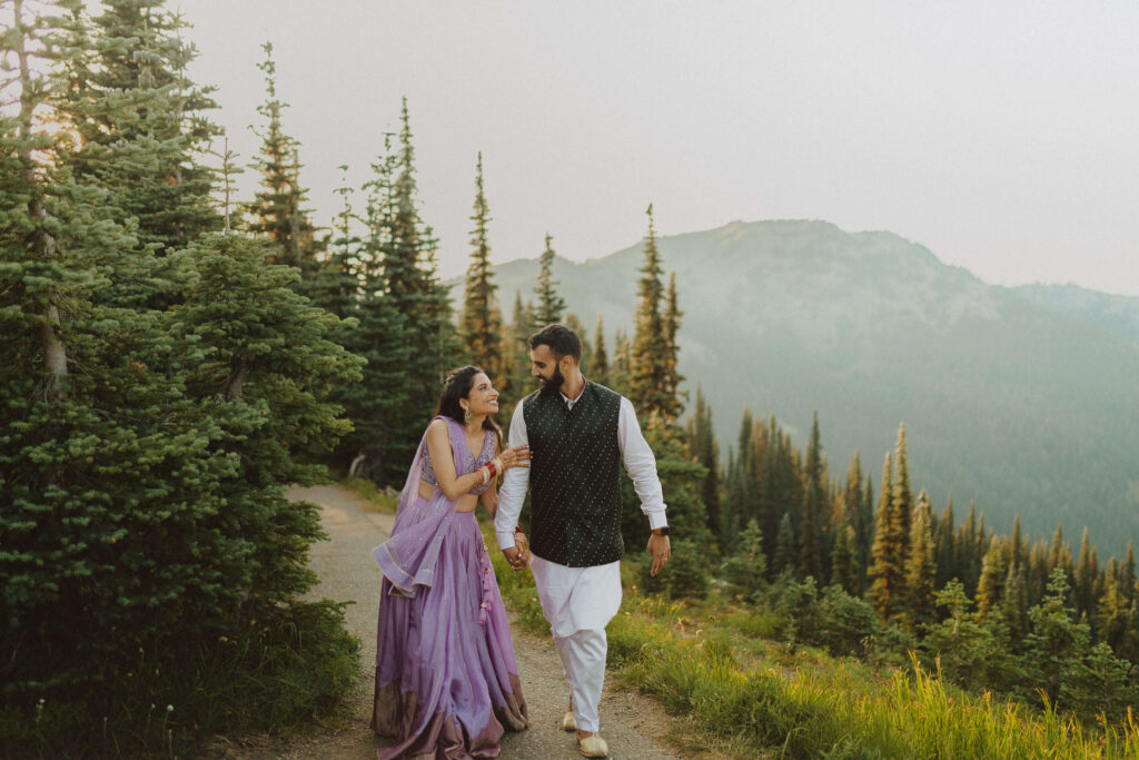 Couple walking and smiling at each other in Olympic National Park