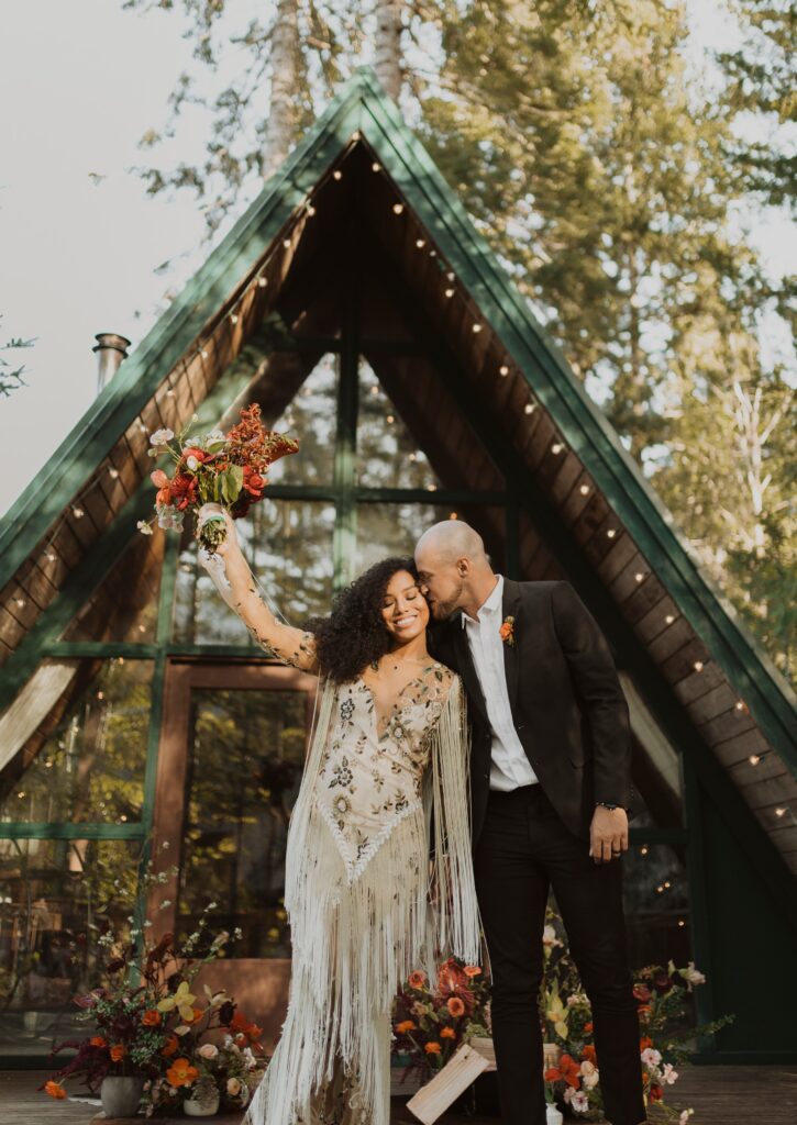 Bride and groom in front of cabin for Washington State elopement