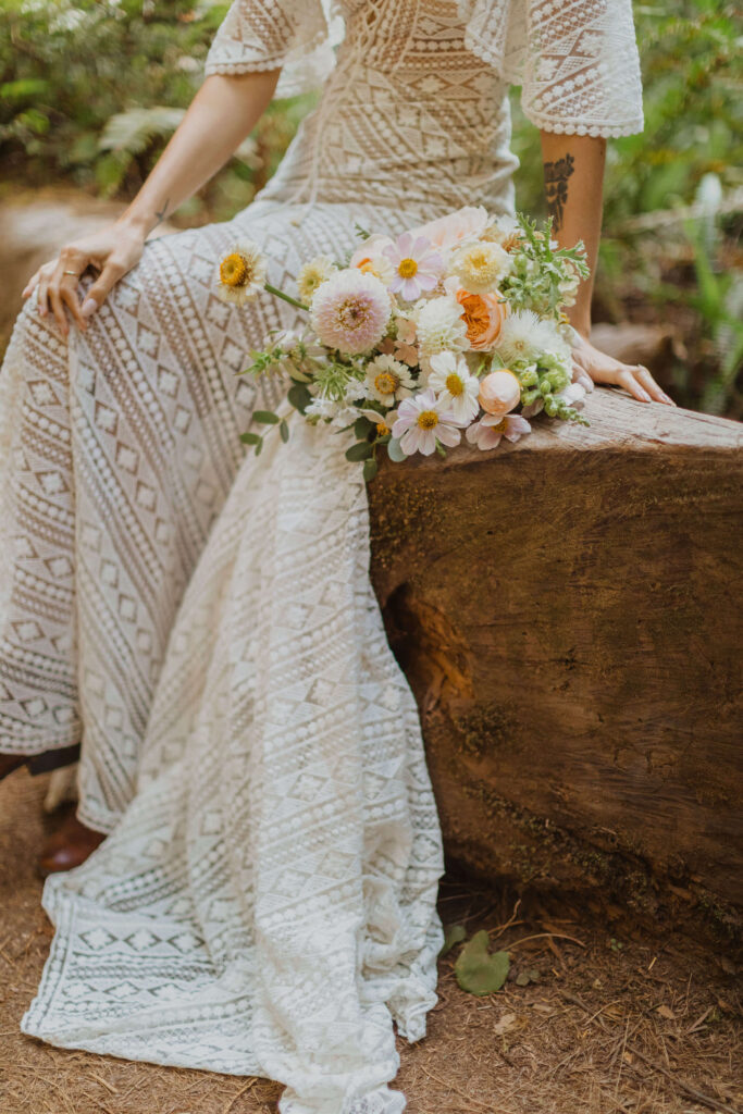bottom half of wedding dress and flower bouquet