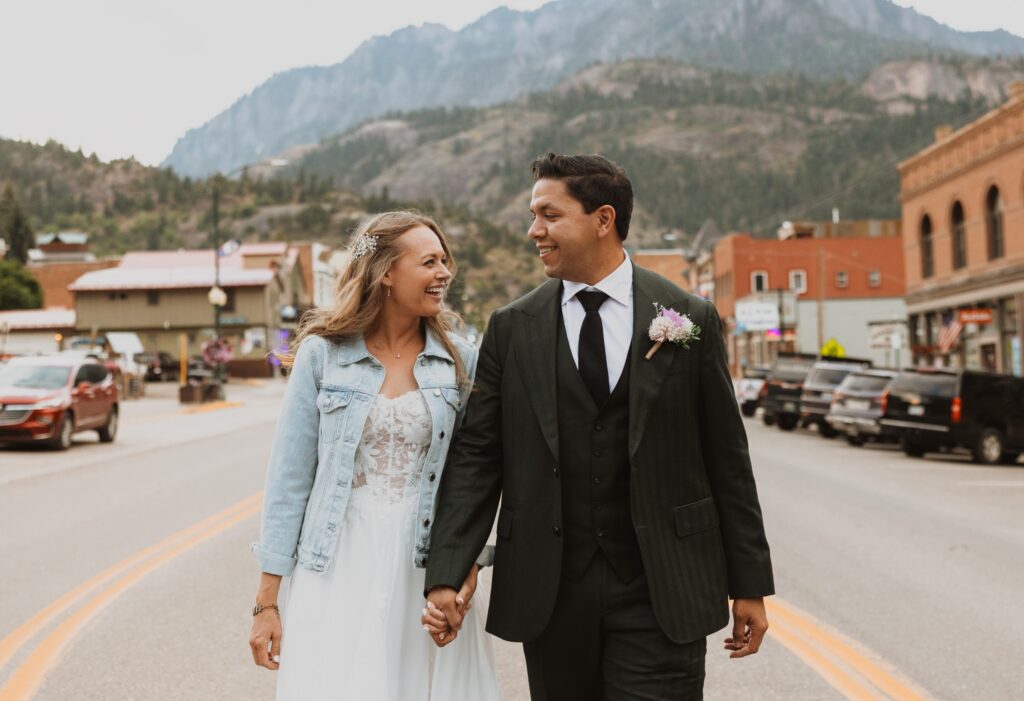 bride and groom walking through downtown Ouray