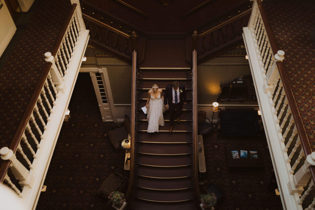 Bride and groom walking on steps at Beaumont Hotel in Ouray