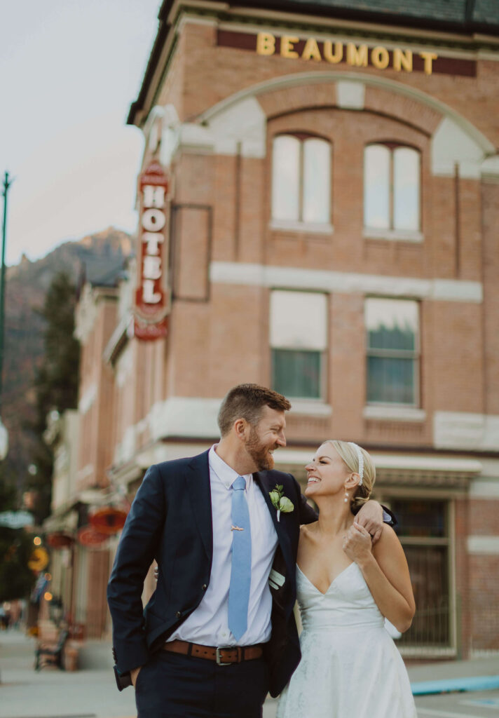 Bride and groom posing in front of Beaumont Hotel for Ouray wedding