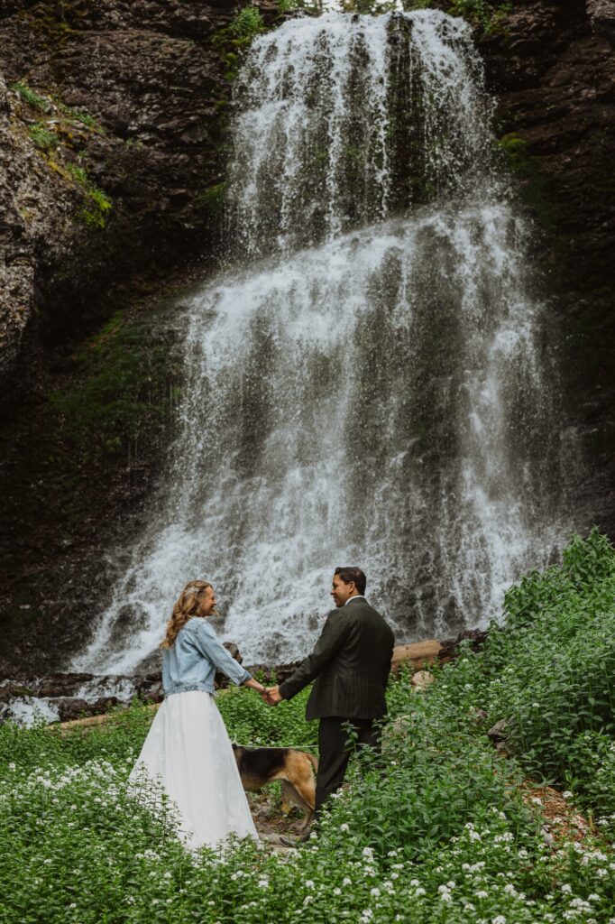 Bride and groom looking at waterfall