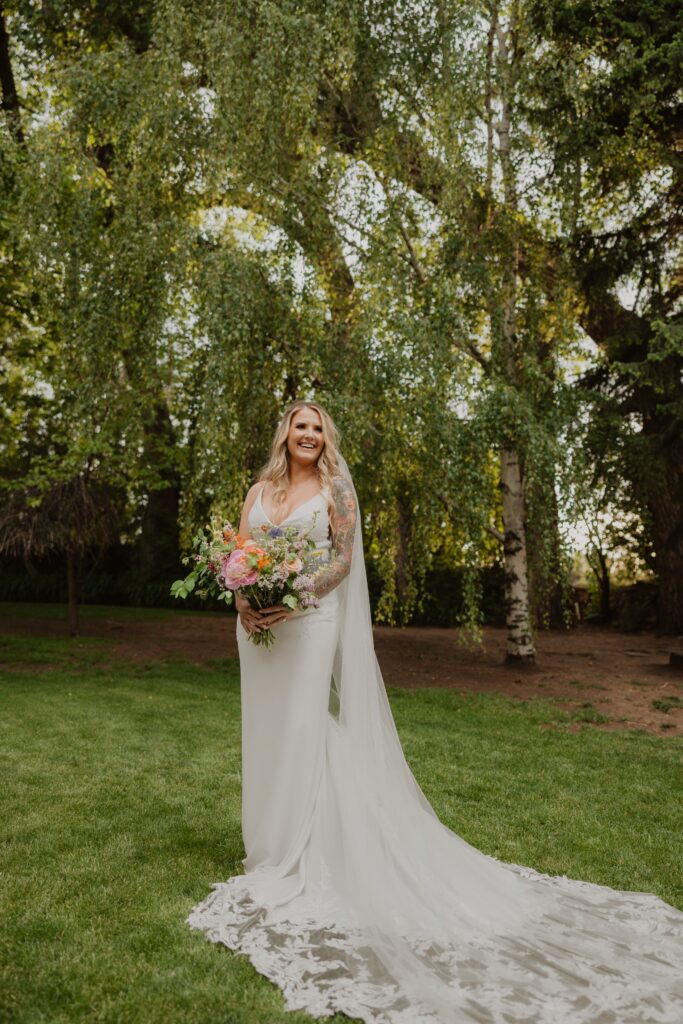 Bride smiling and holding flowers