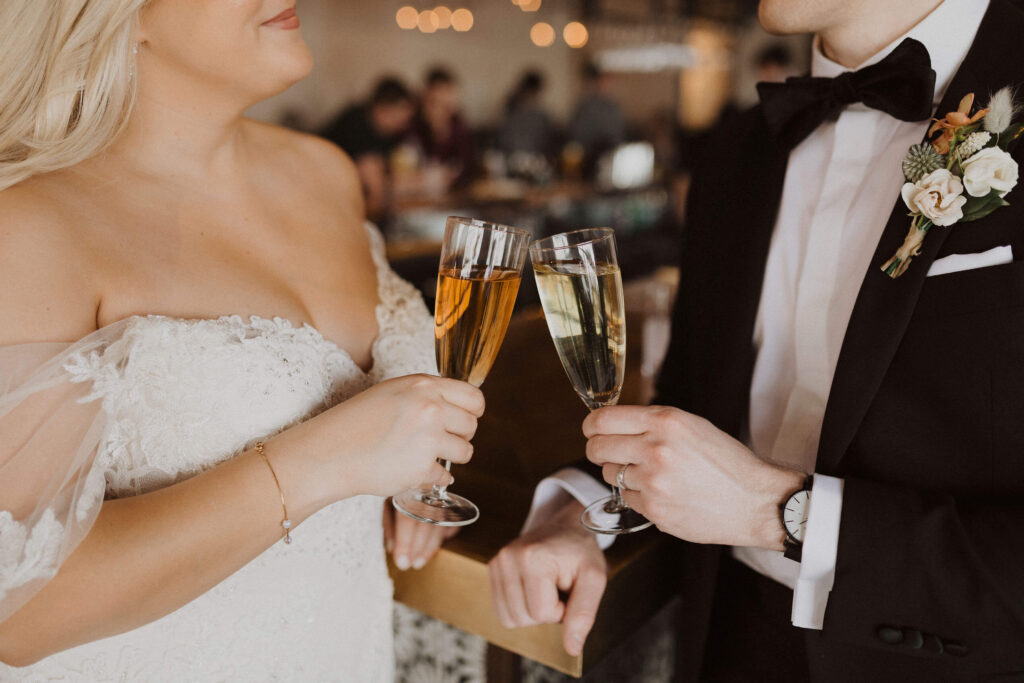 Bride and groom holding champagne