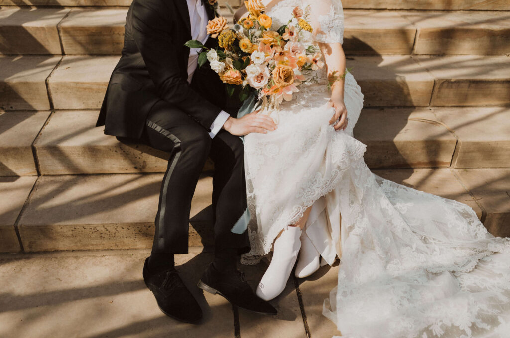 Bride and groom sitting on steps