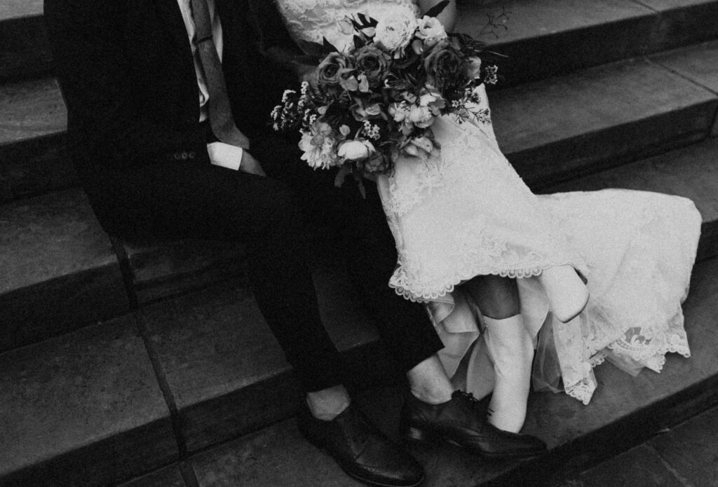 Bride and groom sitting on steps