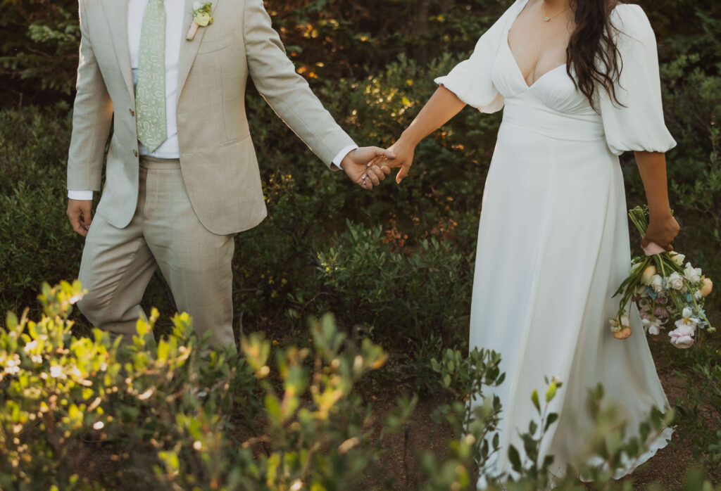bride and groom holding hands and walking outside for wedding in Steamboat Springs
