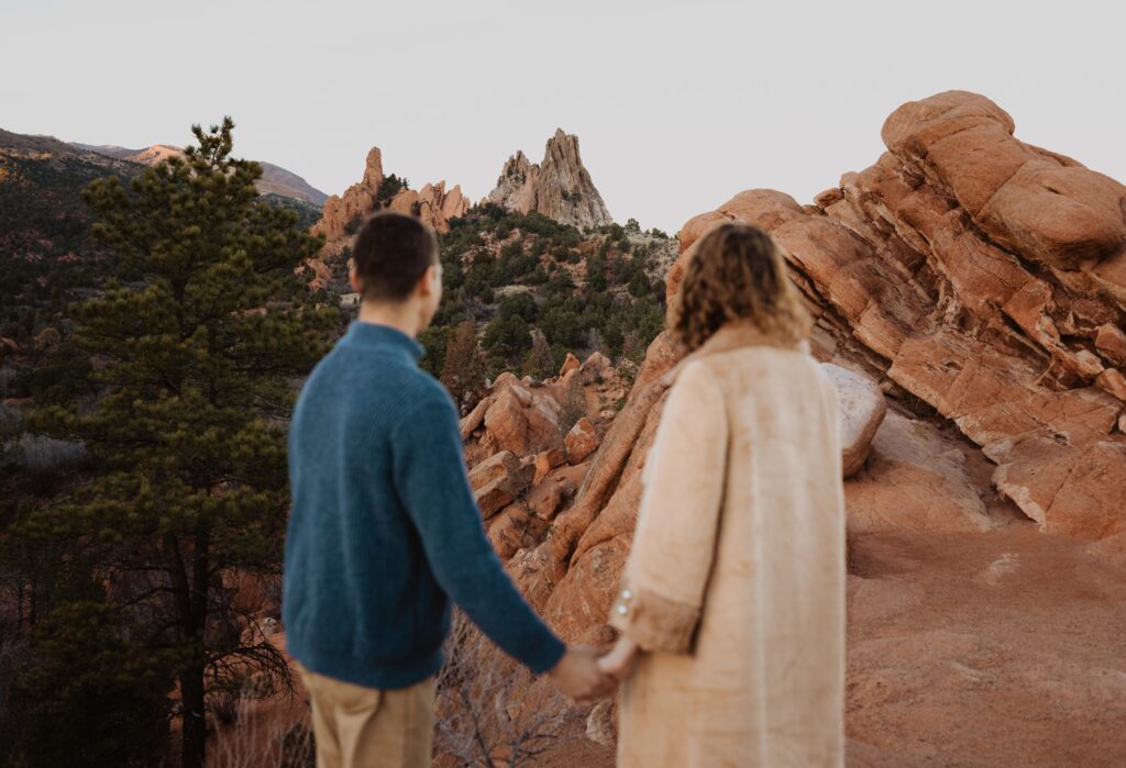 Couple facing red rock formation at Garden of the Gods