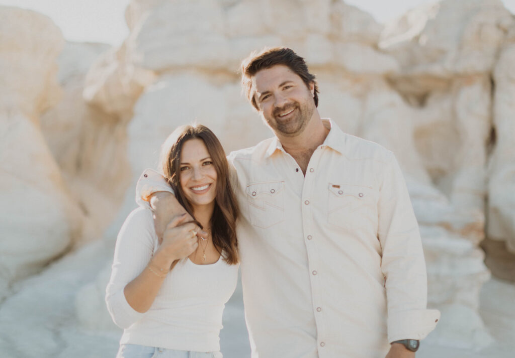 Couple smiling at camera for engagement photos at Paint Mines Interpretive Park