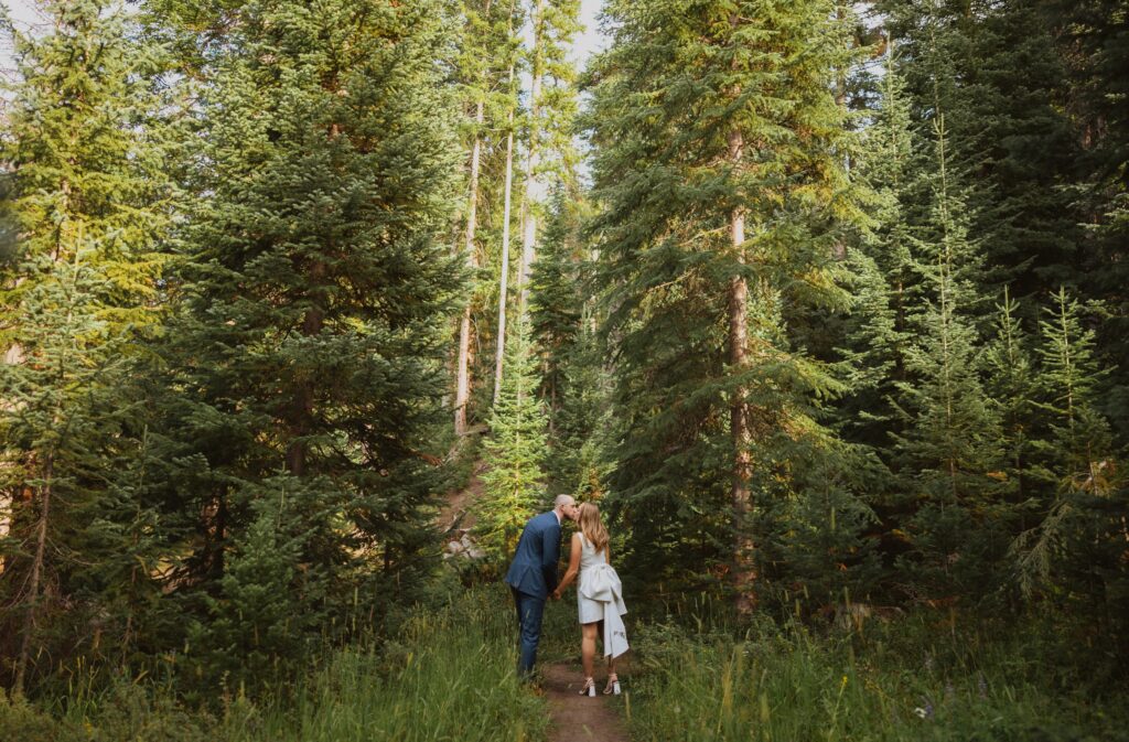 Bride and groom kissing in forest for Steamboat Springs elopement photos
