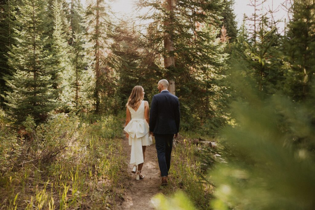 Bride and groom walking in forest for Steamboat Springs elopement photos