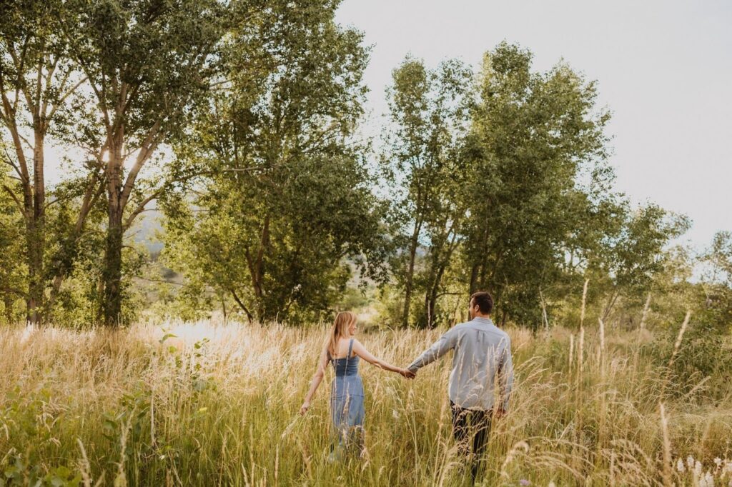 Couple holdings hands facing away from camera