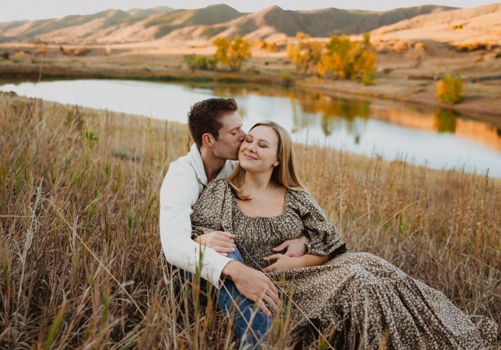 Couple sitting next to lake