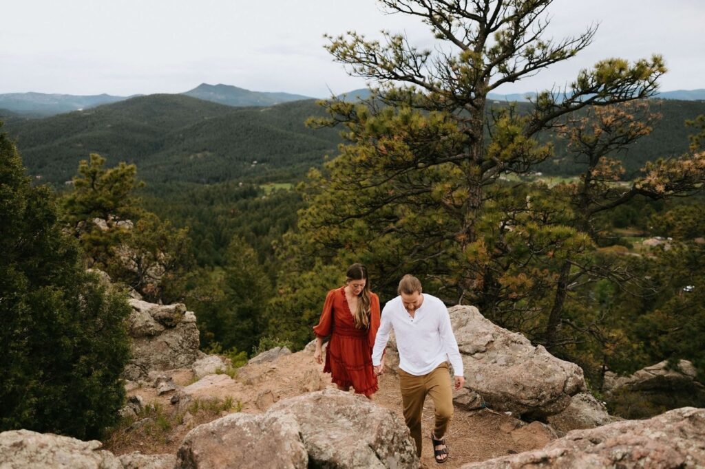 Couple holding hands surrounded by nature