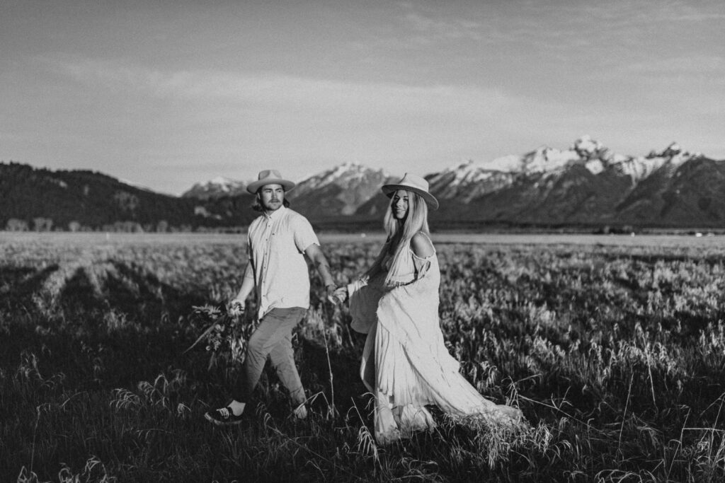 Couple holding hands and smiling at Grand Teton National Park