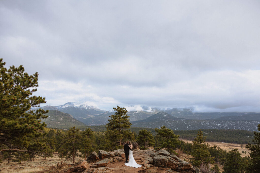 Couple posing in snow at Rocky Mountain National Park for beautiful elopement photo