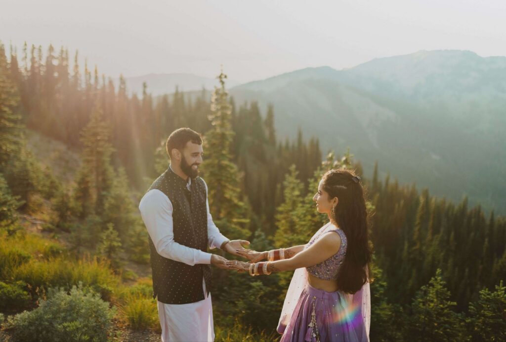 Bride and groom smiling at each other and holding hands