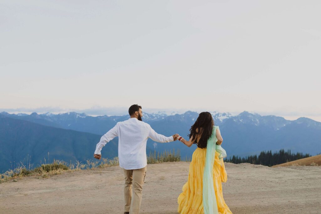 Bride and groom walking towards mountains at Hurricane Ridge