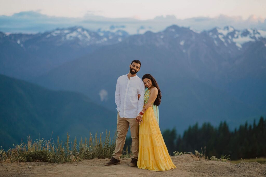 Bride and groom standing in front of mountains at Hurricane Ridge
