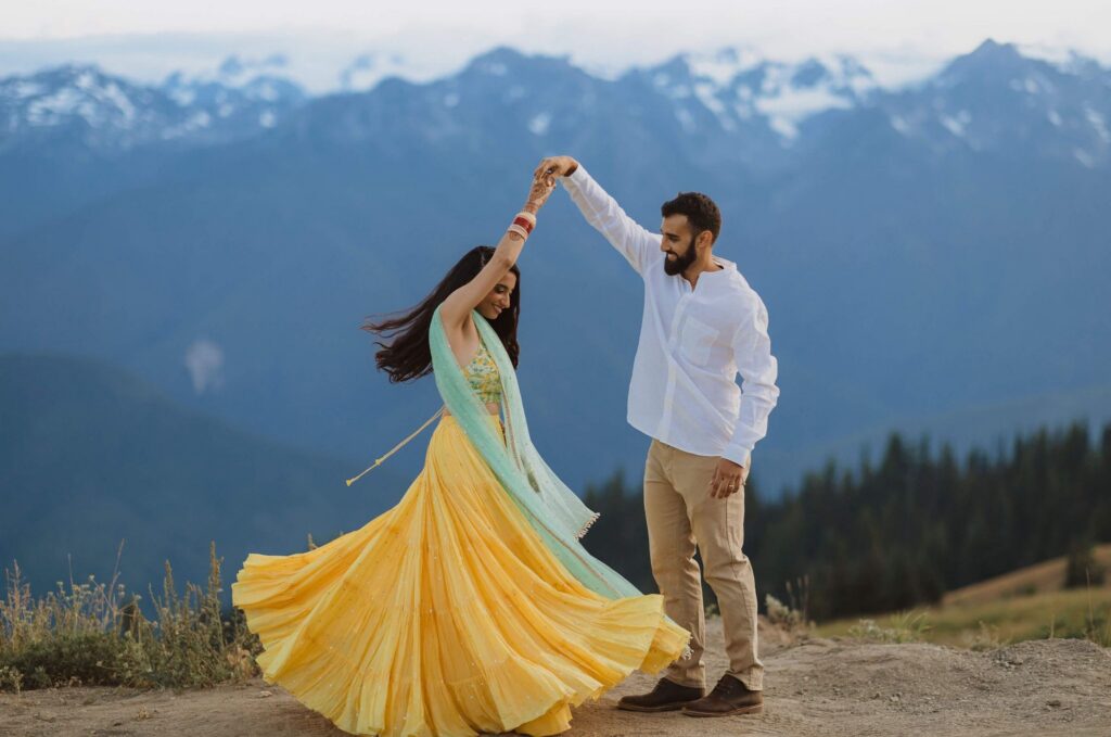 Bride and groom dancing in front of mountains at Hurricane Ridge