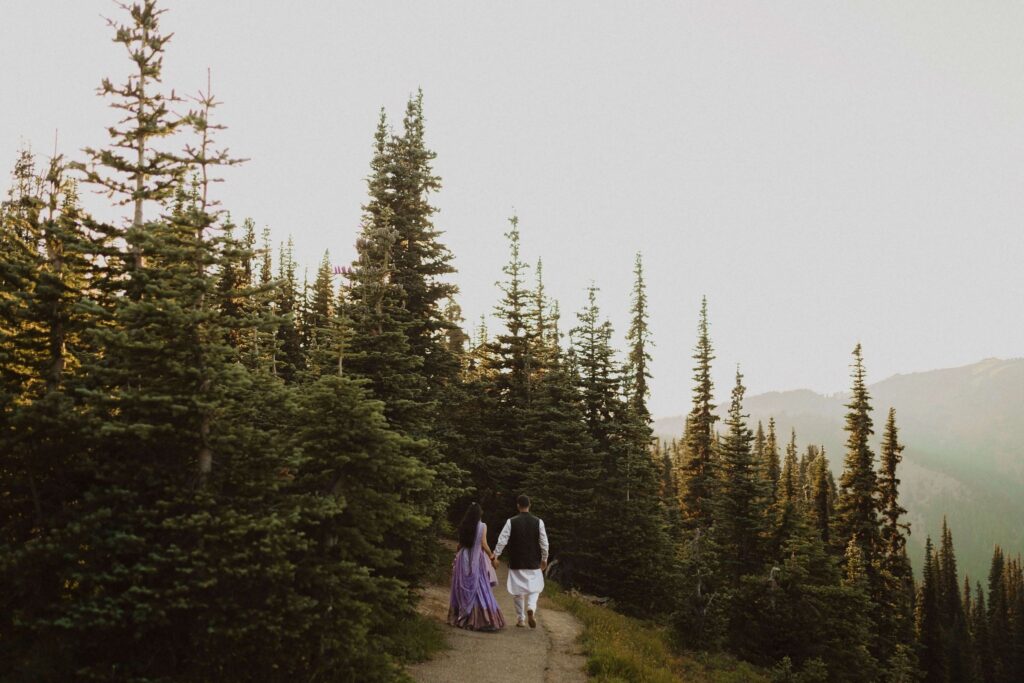 Bride and groom walking away from camera into aspen trees at Hurricane Ridge