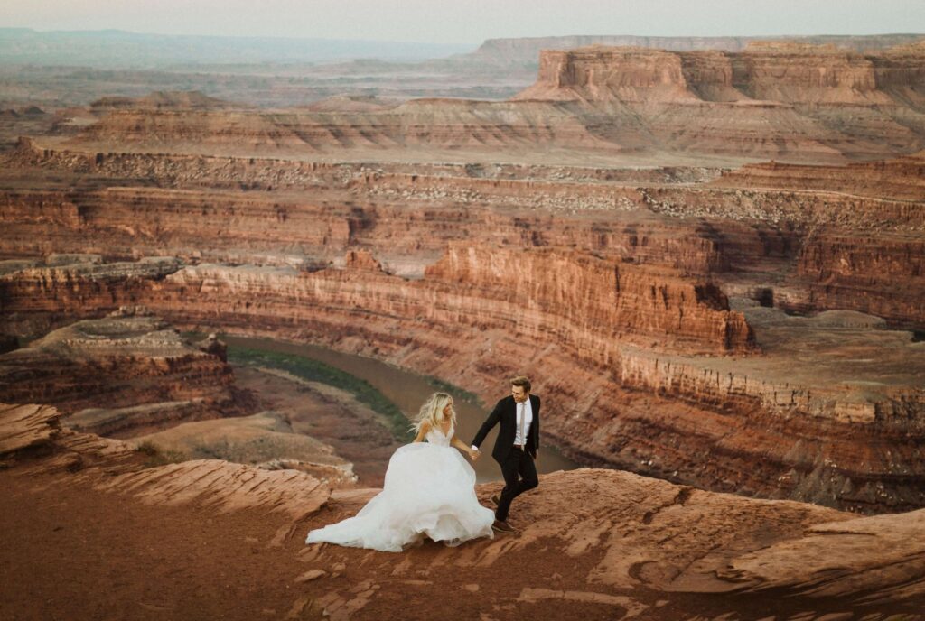 Bride and groom surrounded by red rocks in Utah for elopement