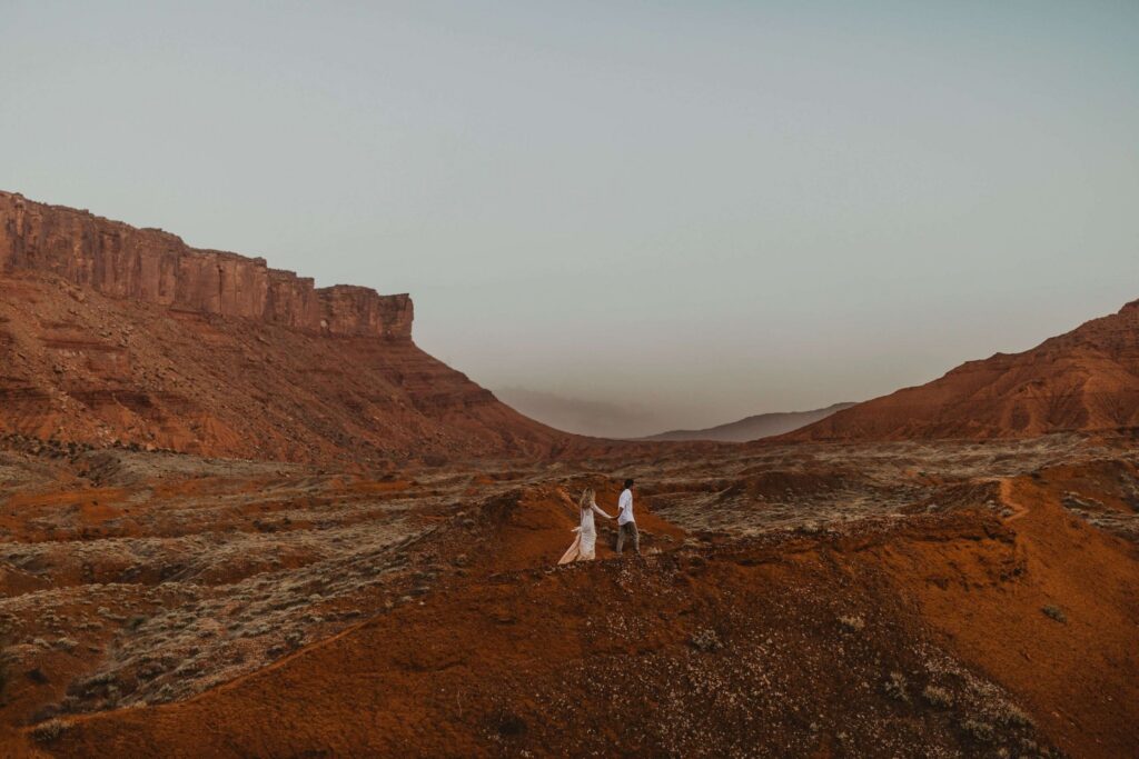 Bride and groom surrounded by red rocks in Utah for elopement