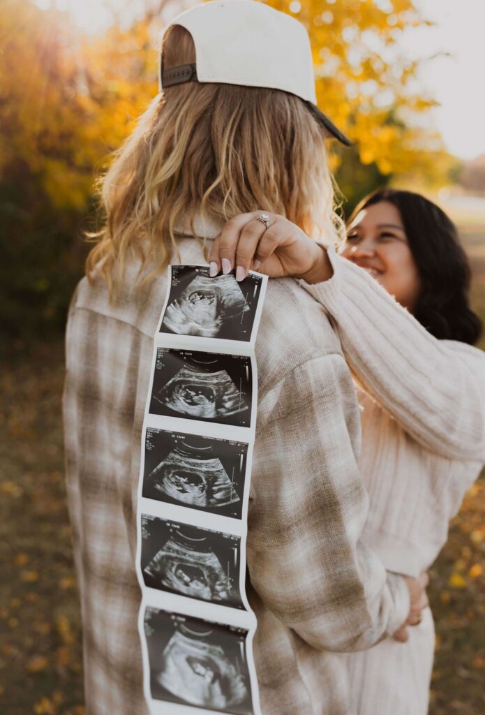 Man with pregnant woman holding sonogram