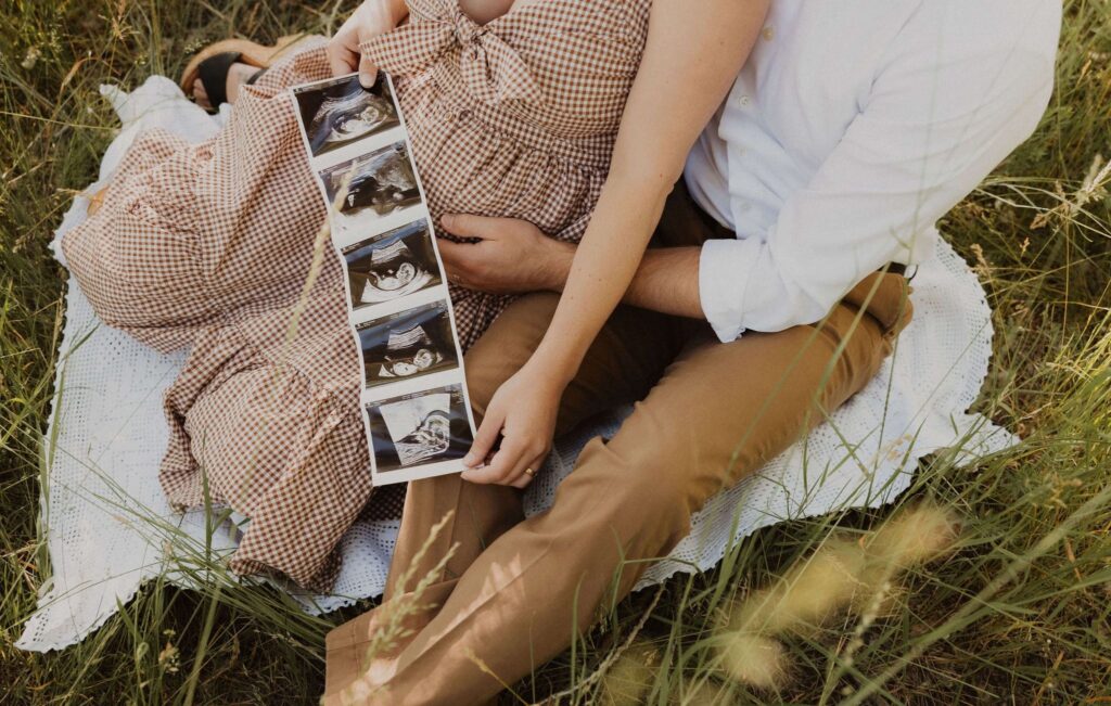 Man and pregnant woman holding sonogram