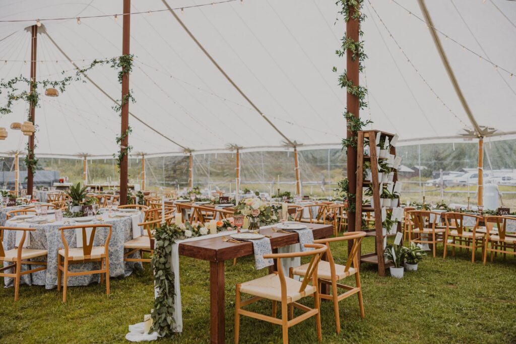 Steamboat Springs wedding reception under a tent with tables and greenery