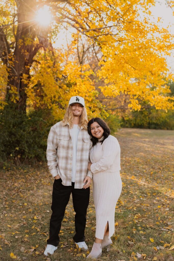 Couple posing surrounded by trees
